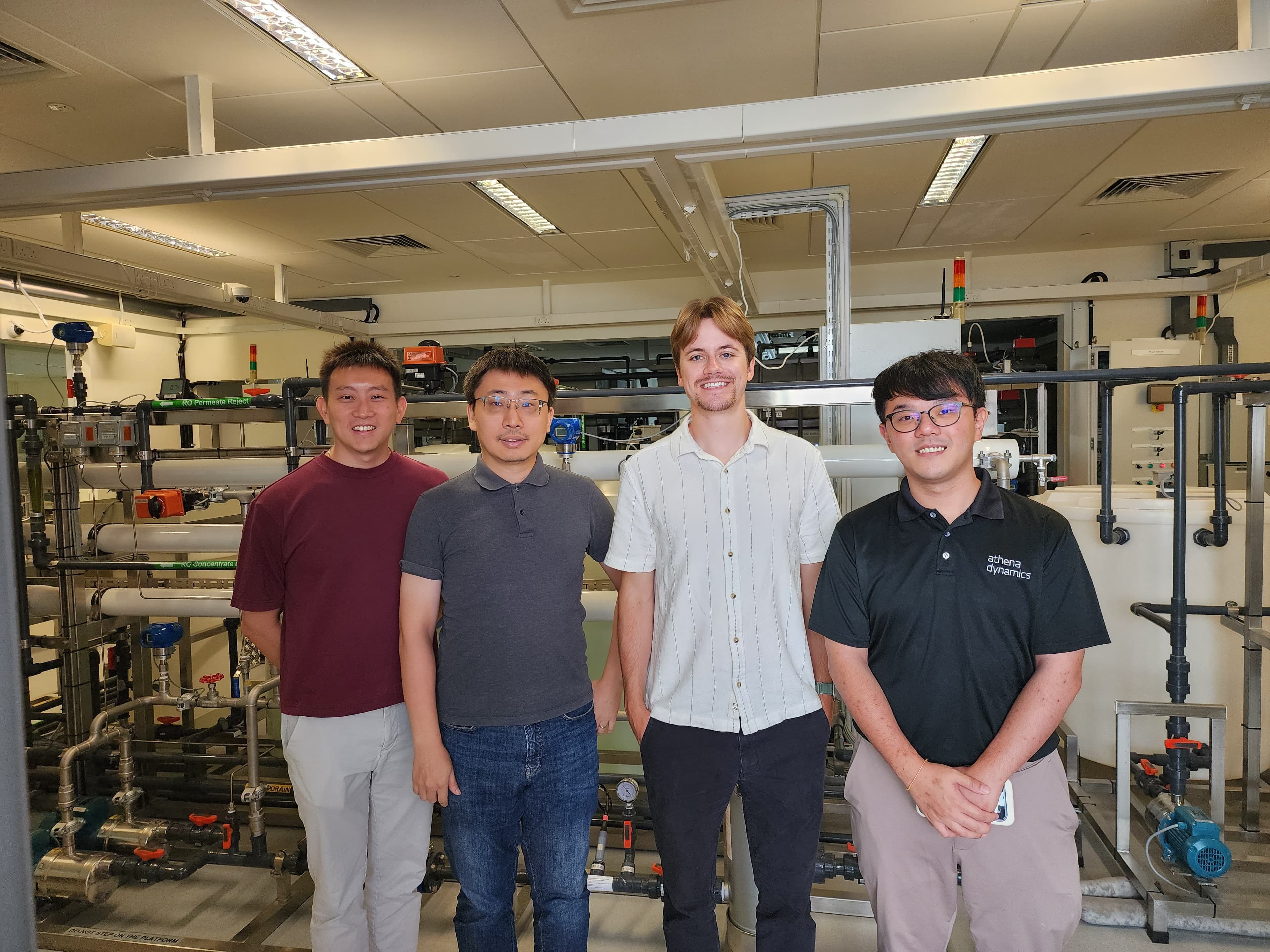 Group photo at CISS in front of industrial testbed equipment